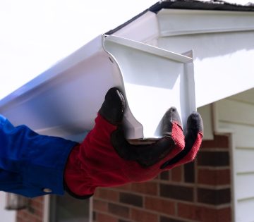 hands on a seamless gutter