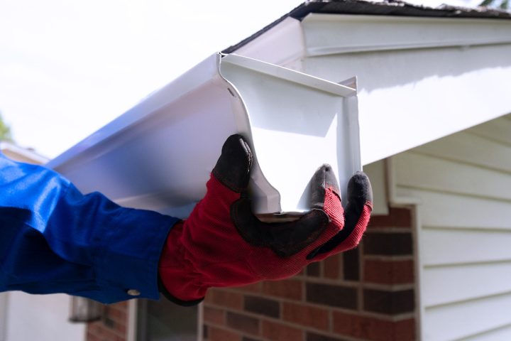 hands on a seamless gutter